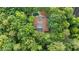 Aerial view of a secluded home with lush surrounding trees and a private pool, showcasing a peaceful and private setting at 10775 Shallowford Rd, Roswell, GA 30075