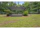 A backyard featuring a dark colored wooden pergola sitting on a well-maintained grassy lawn, perfect for outdoor relaxation at 10775 Shallowford Rd, Roswell, GA 30075