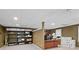 Finished basement featuring a drop ceiling, carpeted floors, and built in shelving at 10775 Shallowford Rd, Roswell, GA 30075