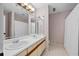 Bathroom featuring a double vanity sink and cabinets, with a shower behind a white curtain at 10775 Shallowford Rd, Roswell, GA 30075