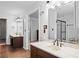 Bathroom with double vanity sink, marble countertop, tile flooring, and shower at 10775 Shallowford Rd, Roswell, GA 30075