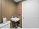 Cozy half bathroom features a sink and white door, offering practicality in a compact space at 10775 Shallowford Rd, Roswell, GA 30075