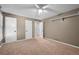 Bedroom featuring neutral walls, carpeted floors, ceiling fan and white doors at 10775 Shallowford Rd, Roswell, GA 30075