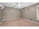 Bedroom with neutral walls, carpeted floors, ceiling fan and white shelving at 10775 Shallowford Rd, Roswell, GA 30075