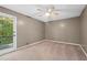 Bedroom with neutral walls, carpeted floors, ceiling fan and walkout deck at 10775 Shallowford Rd, Roswell, GA 30075