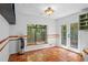 Bright breakfast nook with terracotta tile, large window with green views and access to the deck at 10775 Shallowford Rd, Roswell, GA 30075