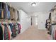 A walk-in closet with wall-to-wall storage and cabinets. Mirror sliding door on back wall at 10775 Shallowford Rd, Roswell, GA 30075