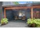 Relaxing covered porch with ceiling fan and comfortable outdoor seating at 10775 Shallowford Rd, Roswell, GA 30075
