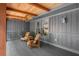 Inviting covered porch with stylish chairs and wood paneled ceiling at 10775 Shallowford Rd, Roswell, GA 30075