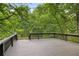 Spacious deck offers views of the surrounding trees and landscape at 10775 Shallowford Rd, Roswell, GA 30075