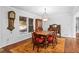 Dining room boasts natural light, hardwood floors, antique furniture, and a vintage clock at 10775 Shallowford Rd, Roswell, GA 30075