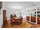 Open-concept dining room features hardwood floors, an antique cabinet, and living room view at 10775 Shallowford Rd, Roswell, GA 30075