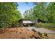 Attractive single-story home with unique modern design and surrounded by mature trees at 10775 Shallowford Rd, Roswell, GA 30075