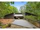 Charming home with a welcoming walkway, mature trees, and unique architectural details at 10775 Shallowford Rd, Roswell, GA 30075