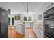 Spacious kitchen featuring white cabinetry, terracotta tile flooring and stainless steel appliances at 10775 Shallowford Rd, Roswell, GA 30075