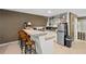This kitchenette has a bar, stainless steel refrigerator, and shelves for extra storage at 10775 Shallowford Rd, Roswell, GA 30075