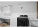 Laundry room features a sink, washer and dryer, and modern farmhouse style at 10775 Shallowford Rd, Roswell, GA 30075