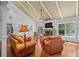 Spacious living room boasts vaulted ceilings, stone fireplace, hardwood floors, and natural light at 10775 Shallowford Rd, Roswell, GA 30075