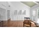 Airy living room features hardwood floors, built-in cabinets, vaulted ceiling, and access to deck at 10775 Shallowford Rd, Roswell, GA 30075
