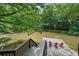 Relaxing waterfront area with a deck and comfortable seating overlooking the calm pond at 10775 Shallowford Rd, Roswell, GA 30075