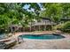 A lovely pool surrounded by stone and lush foliage at 10775 Shallowford Rd, Roswell, GA 30075