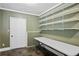 Storage room with ample shelving and slate tile floors at 10775 Shallowford Rd, Roswell, GA 30075