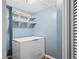 Storage room features a freezer and built in shelving at 10775 Shallowford Rd, Roswell, GA 30075