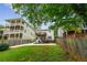 Beautiful backyard view of the home featuring a deck and lush green lawn surrounded by a wooden fence at 34 Montgomery Se St, Atlanta, GA 30317