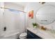 Stylish bathroom with a blue vanity, tub, and a shower with a modern gold shower head at 34 Montgomery Se St, Atlanta, GA 30317