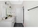Bright bathroom featuring double sinks, white cabinets, and modern fixtures and accents at 34 Montgomery Se St, Atlanta, GA 30317
