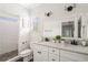 Bright bathroom featuring double vanities, tiled floors, and a walk-in shower at 34 Montgomery Se St, Atlanta, GA 30317