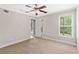 Bedroom with a ceiling fan, neutral carpet, and natural light coming through the window and door to the patio at 34 Montgomery Se St, Atlanta, GA 30317
