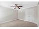 Simple bedroom with neutral carpet, closet, and ceiling fan at 34 Montgomery Se St, Atlanta, GA 30317