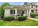 Charming bungalow featuring a covered front porch, swing, white brick, and manicured landscaping at 34 Montgomery Se St, Atlanta, GA 30317
