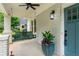 Charming front porch with a hanging swing, brick columns, and a teal front door at 34 Montgomery Se St, Atlanta, GA 30317
