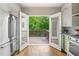 Bright kitchen with stainless steel appliances and French doors to wooden deck and backyard at 34 Montgomery Se St, Atlanta, GA 30317