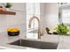Close up of sink, white countertop and the eat in kitchen with wooden shelves at 34 Montgomery Se St, Atlanta, GA 30317