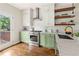 Modern kitchen with stainless steel appliances, white countertops, and green cabinetry at 34 Montgomery Se St, Atlanta, GA 30317