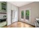 Modern kitchen with stainless steel refrigerator, green cabinets, and French door access to deck at 34 Montgomery Se St, Atlanta, GA 30317