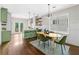 Open kitchen and dining area with modern green cabinetry and hardwood floors at 34 Montgomery Se St, Atlanta, GA 30317