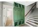 Hallway with a built-in green mudroom cabinet and coat rack, conveniently located next to the stairs at 34 Montgomery Se St, Atlanta, GA 30317
