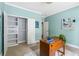 Bright home office features blue walls, stylish storage, wood desk, neutral carpet, and natural light at 34 Montgomery Se St, Atlanta, GA 30317