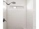 Clean shower featuring white subway tile surround, shower niche and window for natural light at 34 Montgomery Se St, Atlanta, GA 30317