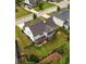 An aerial perspective of a well-kept backyard with a pergola, green grass, and a view of the house's roof at 374 Heritage, Woodstock, GA 30188