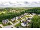 A picturesque aerial view of homes nestled among lush greenery, with a serene lake visible in the background at 374 Heritage, Woodstock, GA 30188