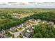 Stunning aerial shot showcasing homes surrounded by lush greenery and a tranquil lake, creating a serene community setting at 374 Heritage, Woodstock, GA 30188
