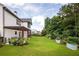 Large backyard featuring a lush lawn, pergola, mature trees, and well-maintained landscaping at 374 Heritage, Woodstock, GA 30188