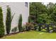Well-maintained backyard showcasing manicured landscaping, a wooden fence, and lush greenery at 374 Heritage, Woodstock, GA 30188