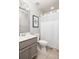Chic bathroom with gray vanity, modern fixtures, and a shower with a white curtain at 374 Heritage, Woodstock, GA 30188