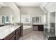 Bright bathroom features a soaking tub, glass shower, double vanity, and shuttered windows at 374 Heritage, Woodstock, GA 30188